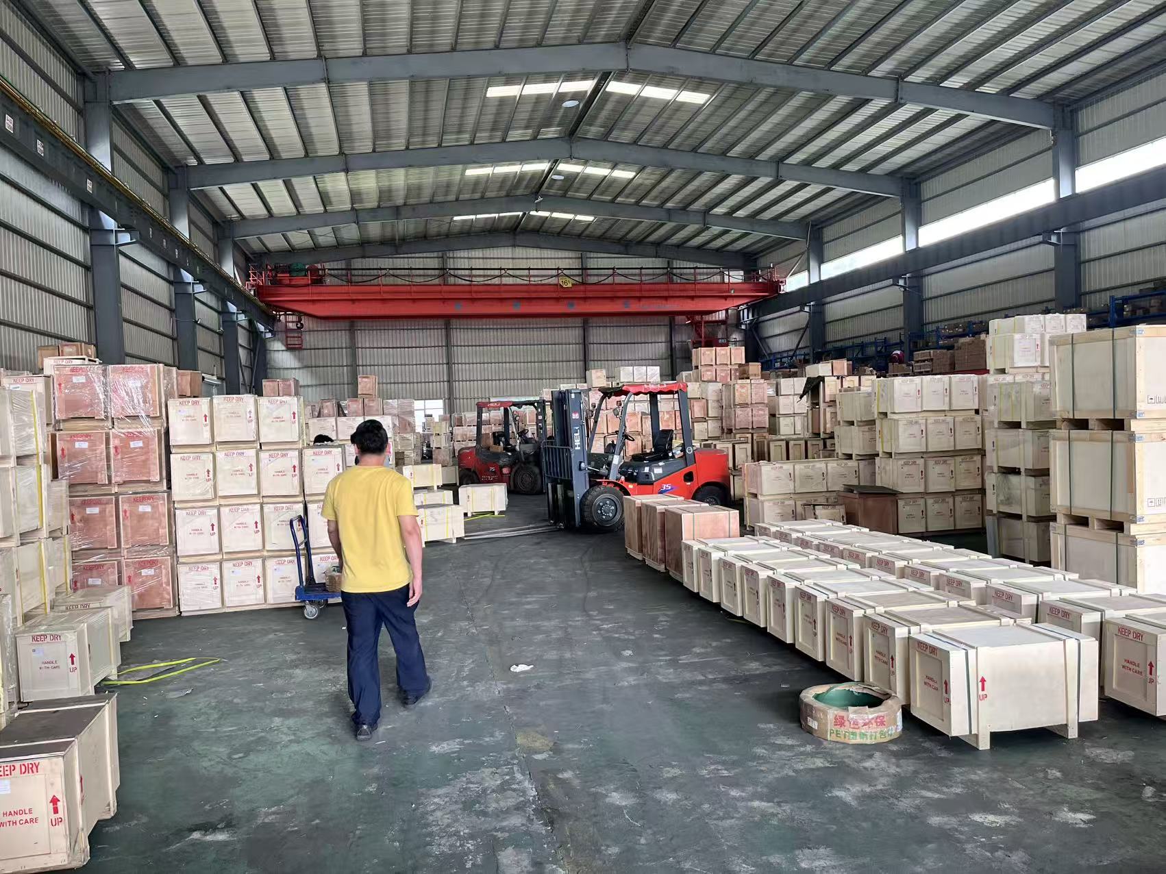Excavator parts prepared in wooden export cases at a China warehouse