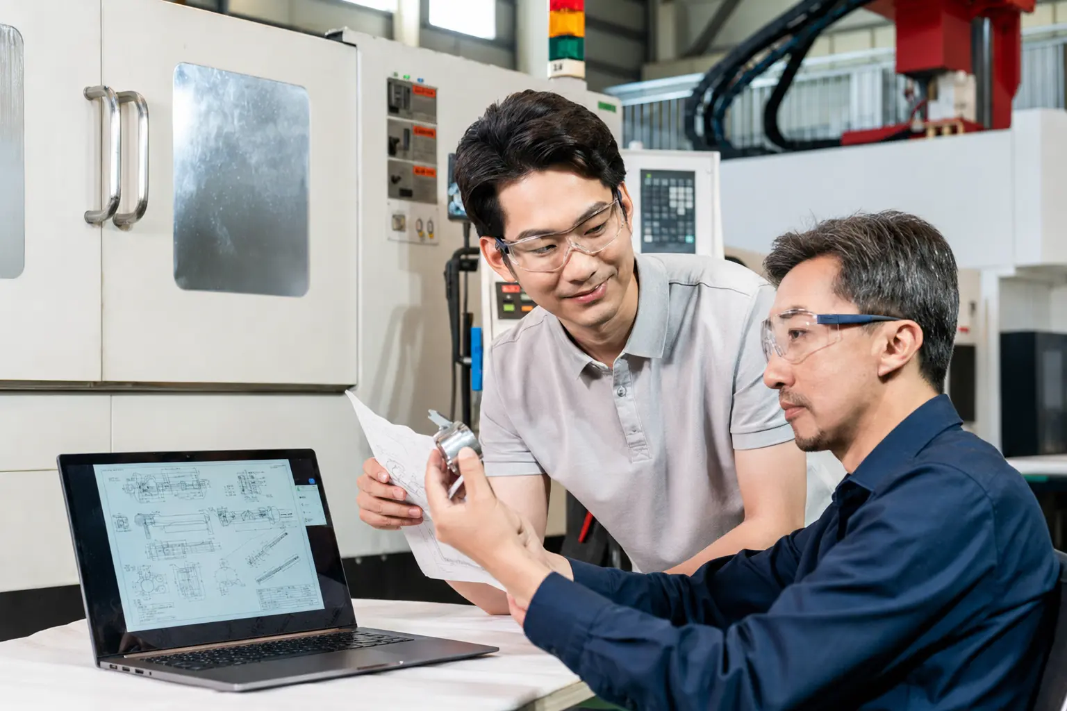 Technical team confirming excavator parts specifications before an order